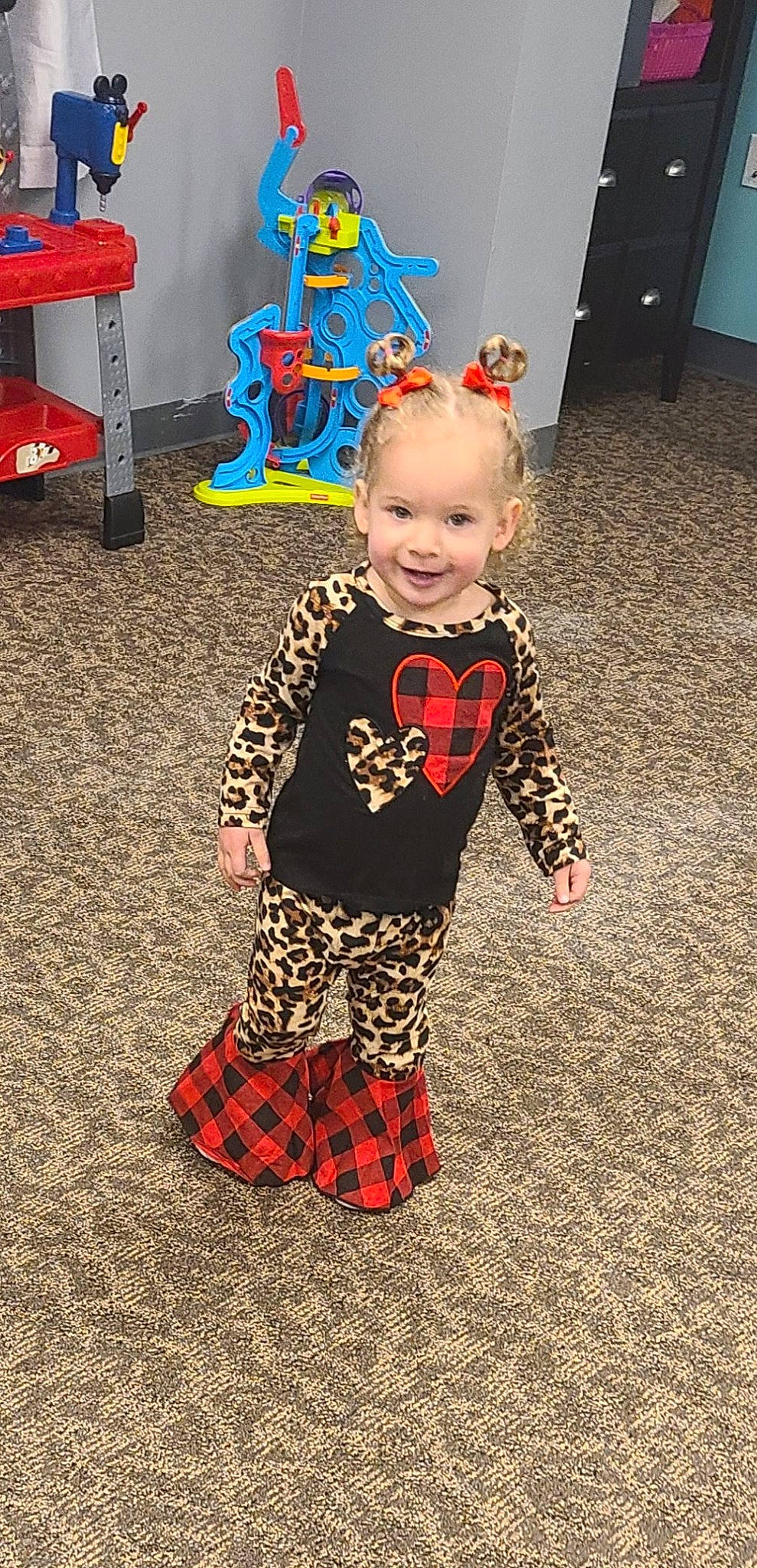 Desleigh joined the competition — help win amazing prizes! baby, baby_toddler_clothing, chair, child, event, face, flooring, fun, holiday, joy, pajamas, pattern, person, plaid, red, sitting, sleeve, smile, standing, table