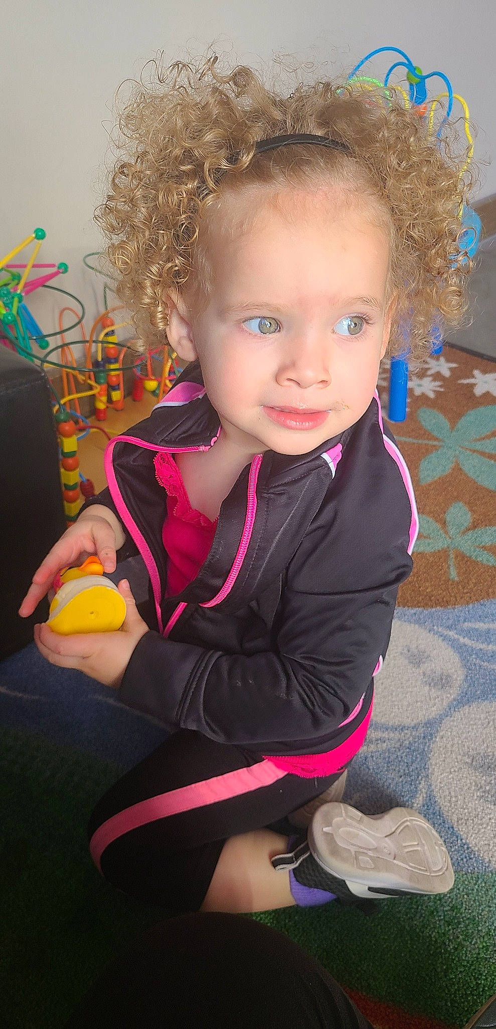 Desleigh is registered to the contest to win money with this photo: baby_toddler_clothing, blond, cheek, child, clothing, eye, face, flooring, fun, hair, hairstyle, happy, head, lip, magenta, person, pink, skin, smile, sock