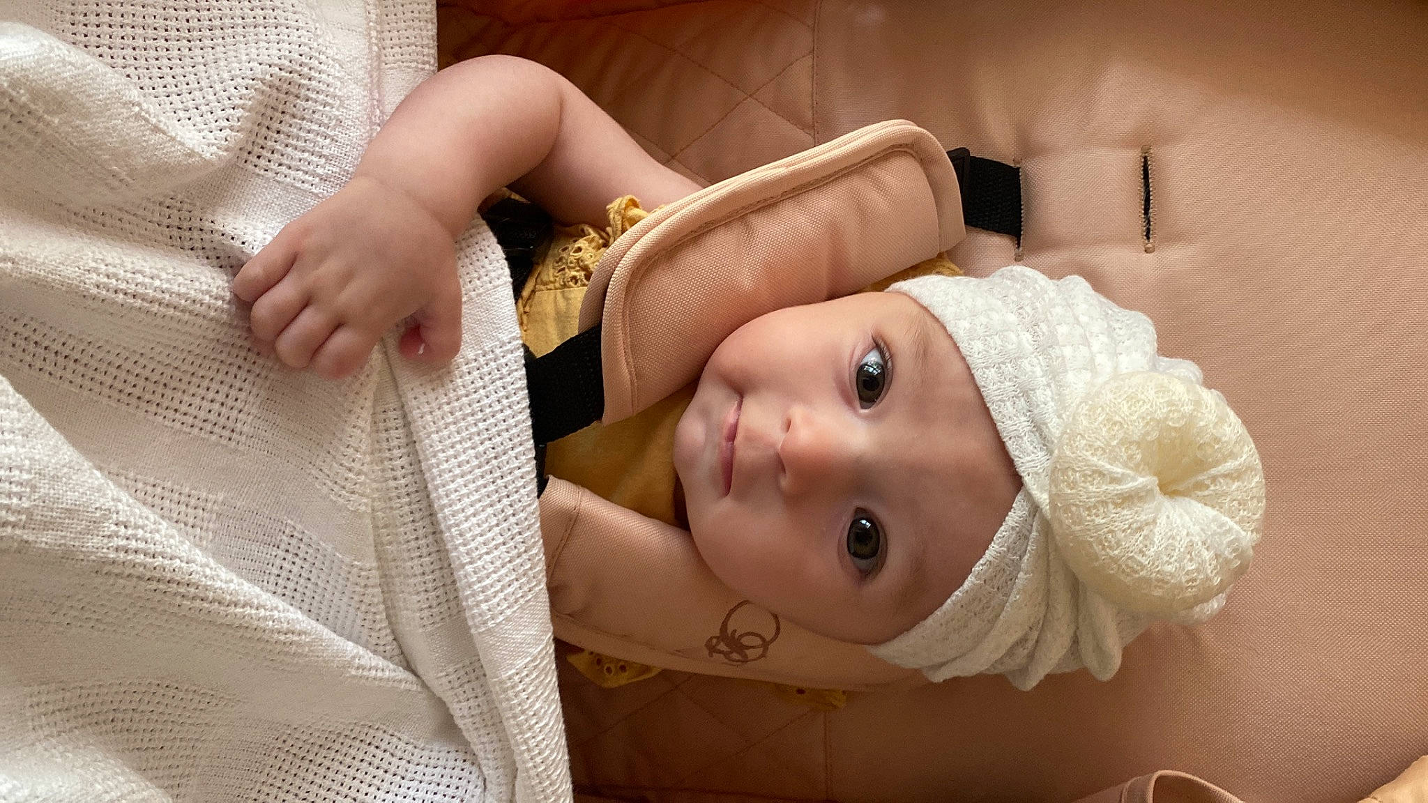 Arabella is registered to the contest to win money with this photo: baby, baby_safety, baby_sleeping, baby_toddler_clothing, blond, cap, child, comfort, eyebrow, eyelash, finger, flash_photography, happy, headwear, linens, lip, person, room, skin, smile