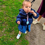 Keana joined the competition — help win amazing prizes! toddler, child, outdoor, grass, sidewalk, jacket, denim, leash, adult_hand, footwear, crocs, flower, curious, walking, nature, person, clothing, baby_shoes, pavement, playful