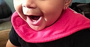 Armani joined the competition — help win amazing prizes! adorable, baby, black_clothing, child, close_up, couch, earring, eyes, face, happy, home, indoors, infant, laughing, open_mouth, photography, pink_bib, portrait, sitting, smiling