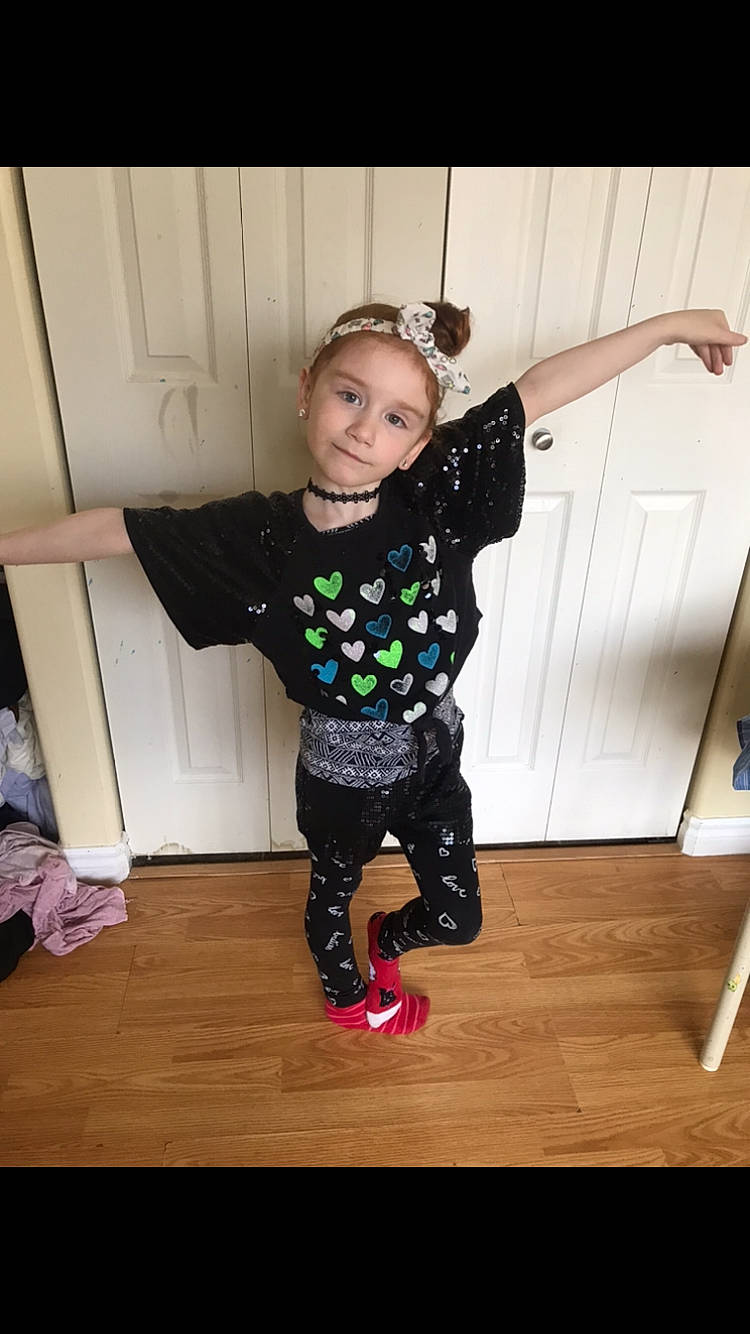 Phoenix is registered to the contest to win money with this photo: arm, child, cool, costume, footwear, fun, happy, joint, leg, leggings, person, shoe, smile, t_shirt, toddler