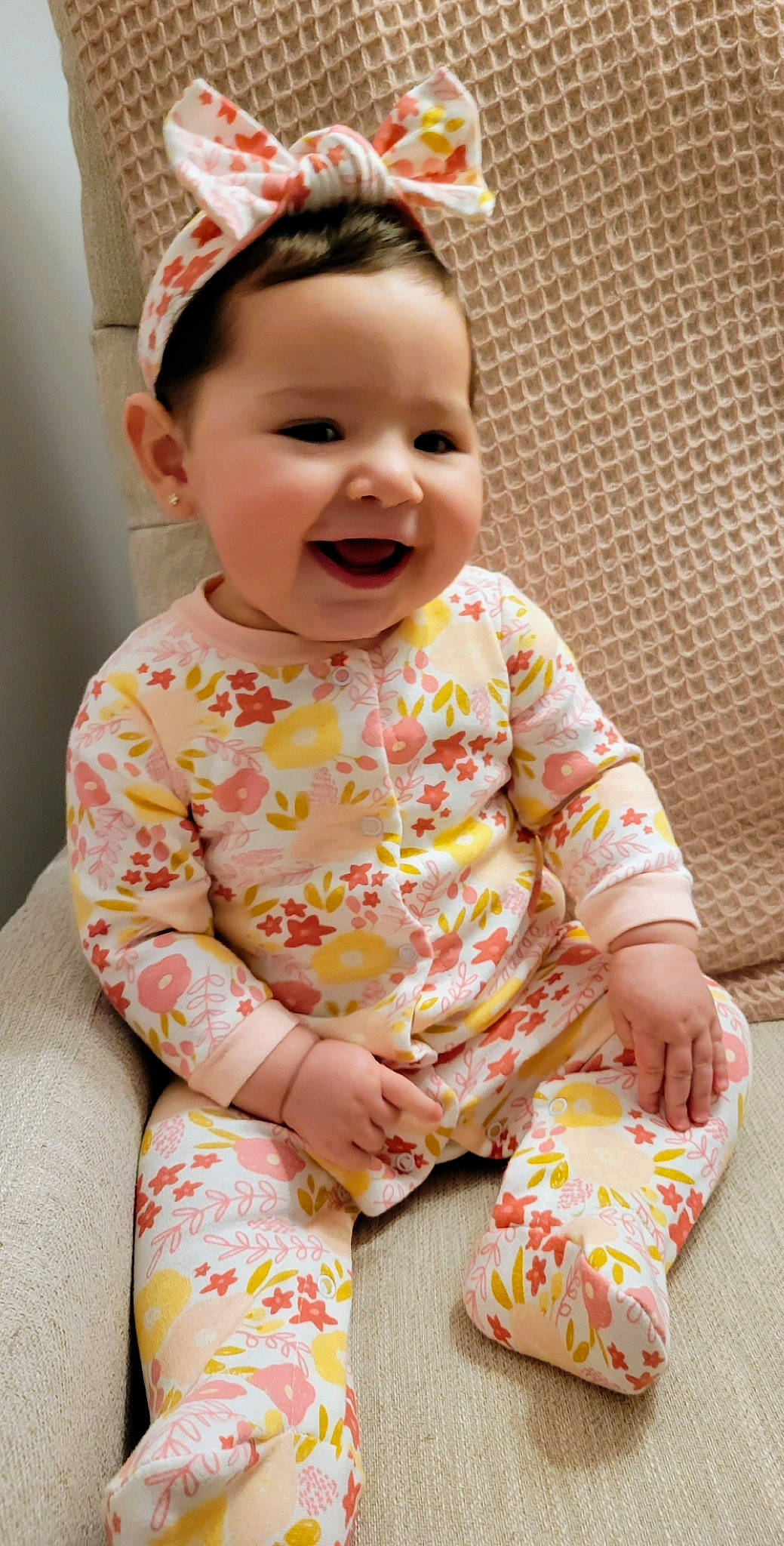 Mila joined the competition — help win amazing prizes! baby, baby_laughing, baby_toddler_clothing, cap, cheek, child, dress, face, fashion_accessory, happy, head, headband, joy, pattern, person, pink, sitting, skin, sleeve, smile