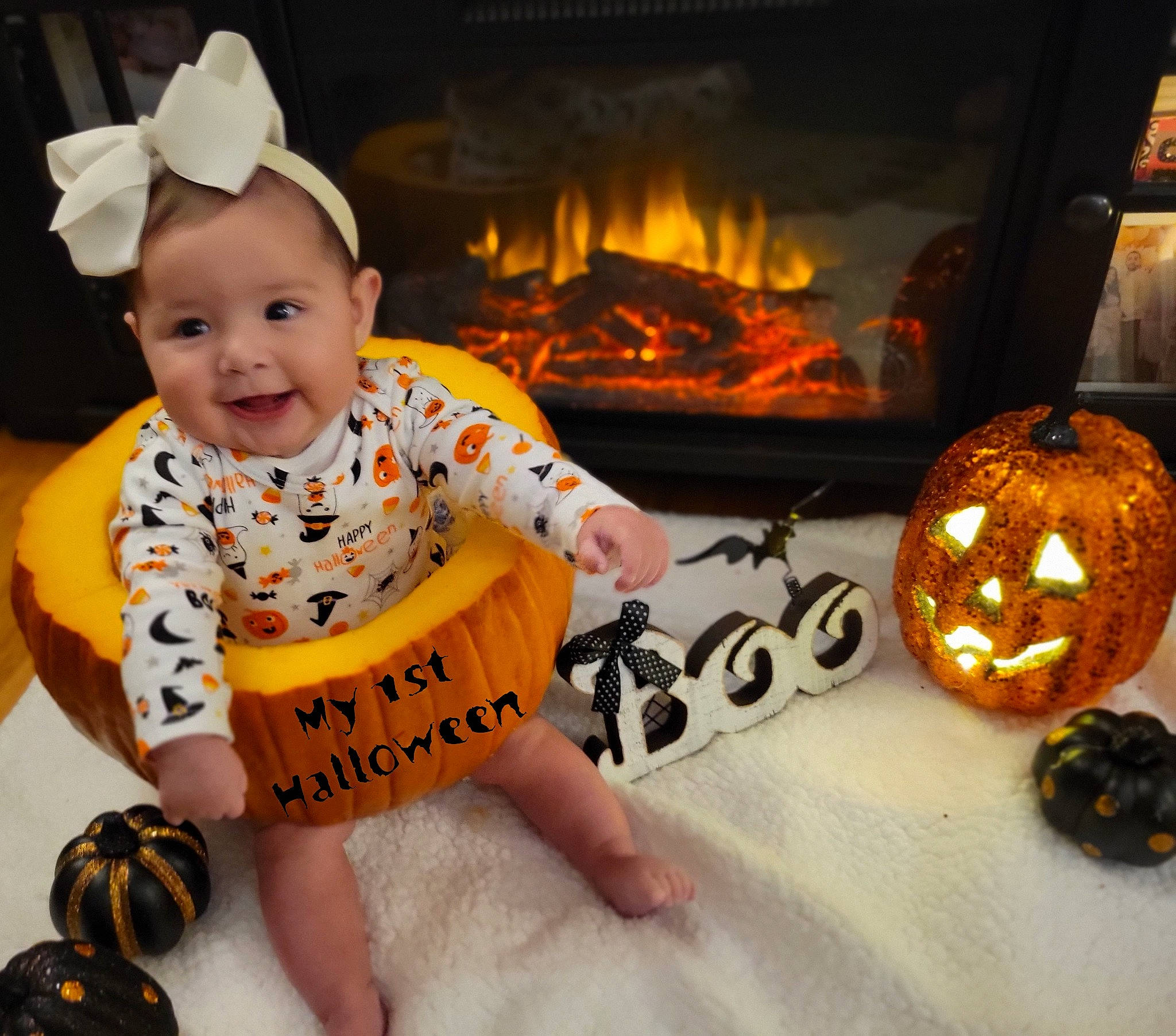 Mila joined the competition — help win amazing prizes! baby, baby_toddler_clothing, calabaza, child, fire, fireplace, flooring, fun, gas, gourd, happy, hearth, heat, joy, orange, person, pumpkin, sleeve, smile, toddler
