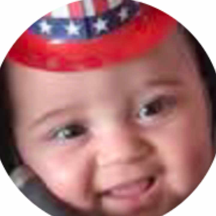 Trinity joined the competition — help win amazing prizes! baby, face, smiling, hat, red_hat, blue, white, stars, portrait, child, cute, headwear, round_crop, closeup, young_child, happy, infant, person, expression, skin