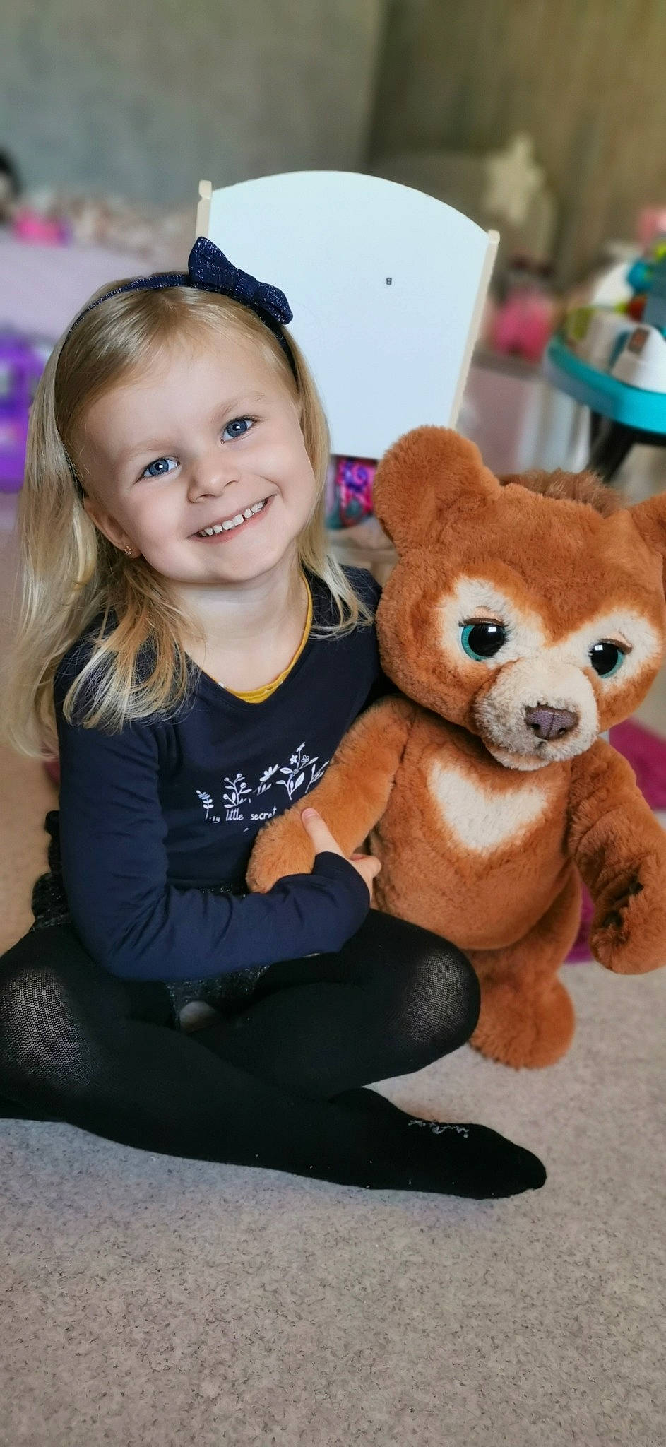 Léanna a rejoint le concours — aidez-le/la à gagner de superbes lots ! chair, companion_dog, eye, fawn, flash_photography, flooring, fun, fur, happy, joy, mammal, person, plush, sitting, skin, smile, stuffed_toy, terrestrial_animal, toddler, toy