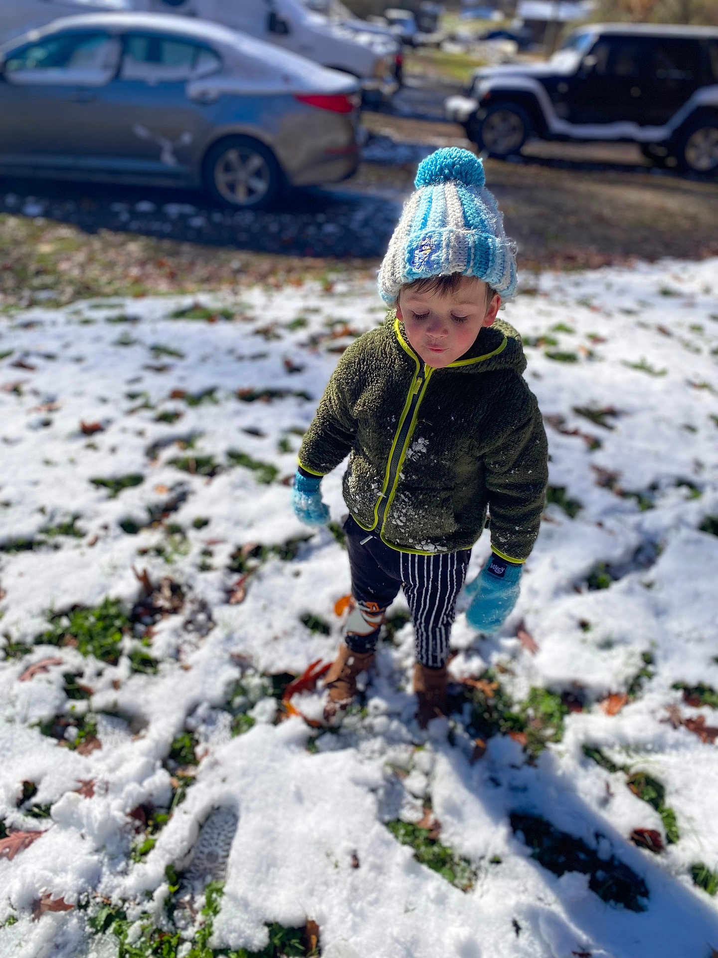 Memphis Ridge Kinder joined the competition — help win amazing prizes! child, snow, winter_clothing, hat, gloves, jacket, pants, boots, outdoor, daylight, car, grass, leaf, footprint, cold_weather, parked_vehicle, street, person, young_child, winter
