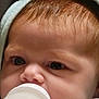 Amanda joined the competition — help win amazing prizes! baby, infant, bottle, feeding, close_up, face, eyes, mouth, nose, hair, blanket, hood, skin, newborn, cute, portrait, milk_bottle, bottle_feeding, indoors, cozy