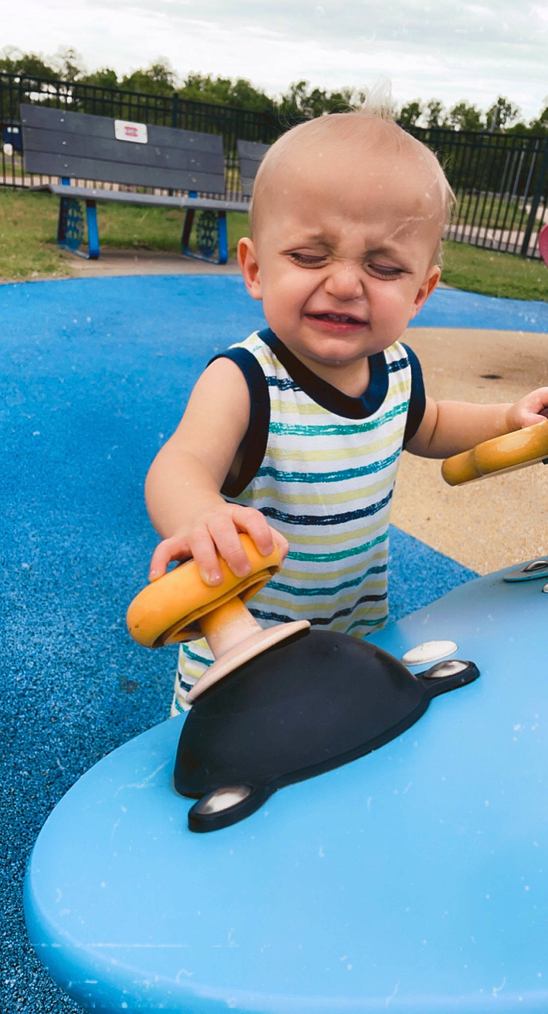 Barrett is registered to the contest to win money with this photo: arm, baby, baby_toddler_clothing, blue, child, city, finger, fish, fun, grass, hairstyle, leisure, person, play, recreation, sitting, sky, smile, sorrow, t_shirt