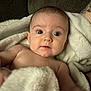 baby, bare_chest, blanket, closeup, couch, cozy, cute, face, family, head, indoors, infant, looking_at_camera, newborn, portrait, skin, soft_texture, surprised_expression, towel, wide_eyes