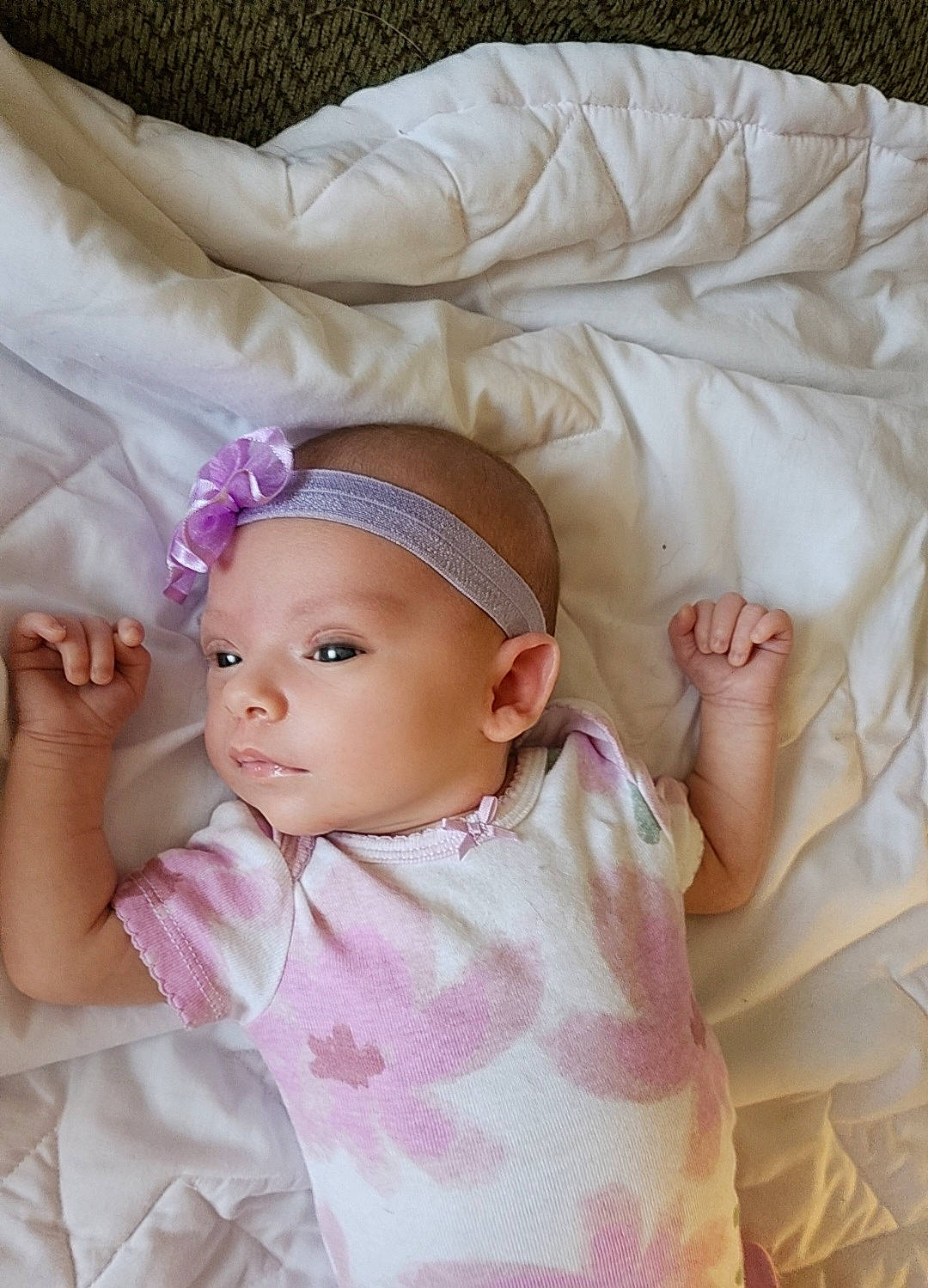 Brailee is registered to the contest to win money with this photo: baby, baby_sleeping, baby_toddler_clothing, cheek, child, comfort, eyelash, fashion_accessory, hair_accessory, headband, linens, magenta, pattern, person, pink, purple, skin, sleeve, textile, toddler