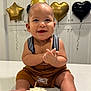 Amor is registered to the contest to win money with this photo: baby, birthday, party_hat, cake, smiling, table, balloons, gold, black, celebration, suspenders, indoor, cute, happy, child, face, legs, toes, food, festive