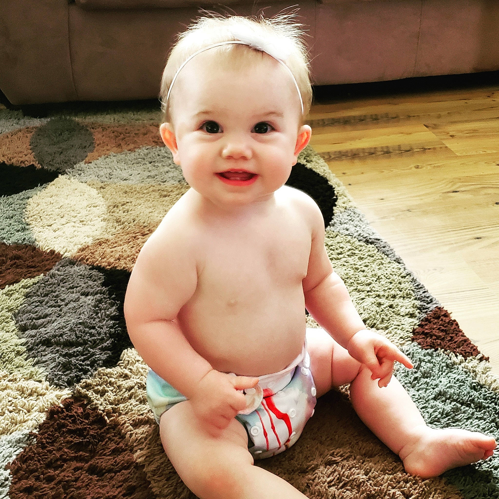 Brooklyn is registered to the contest to win money with this photo: baby, baby_toddler_clothing, cheek, child, eye, face, head, human, leg, lip, person, sitting, skin, smile, summer, toddler