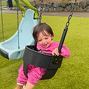 Willow joined the competition — help win amazing prizes! boots, casual, chains, child, daylight, fun, grass, greenery, happy, outdoor, park, pink_clothing, play, playground, recreation, smiling, swing, toddler, trees, young_child