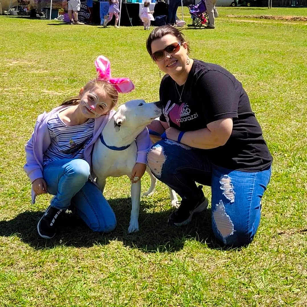 Mattie is registered to the contest to win money with this photo: clothing, event, eyewear, fawn, fun, glasses, grass, grass_family, happy, hat, jeans, lap, lawn, leisure, recreation, shorts, smile, sunglasses, t_shirt, working_animal