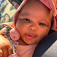 Loa Nawi participe au concours pour gagner de l'argent avec cette photo : baby, child, face, hand, pacifier, beads, hood, clothing, pink, closeup, portrait, cute, infant, skin, expression, warm_light, outdoor, person, young_child, holding