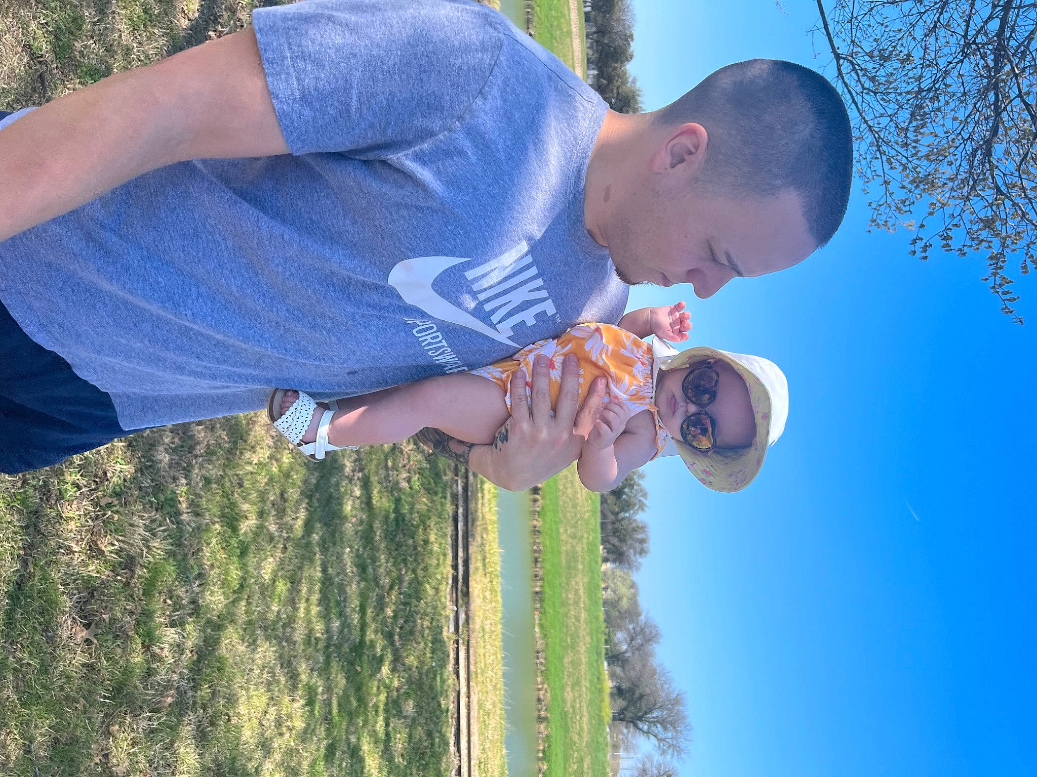 Millie is registered to the contest to win money with this photo: blue, child, elbow, electric_blue, fun, gesture, grass, grassland, happy, leisure, people_in_nature, person, plant, recreation, sky, t_shirt, tree, water