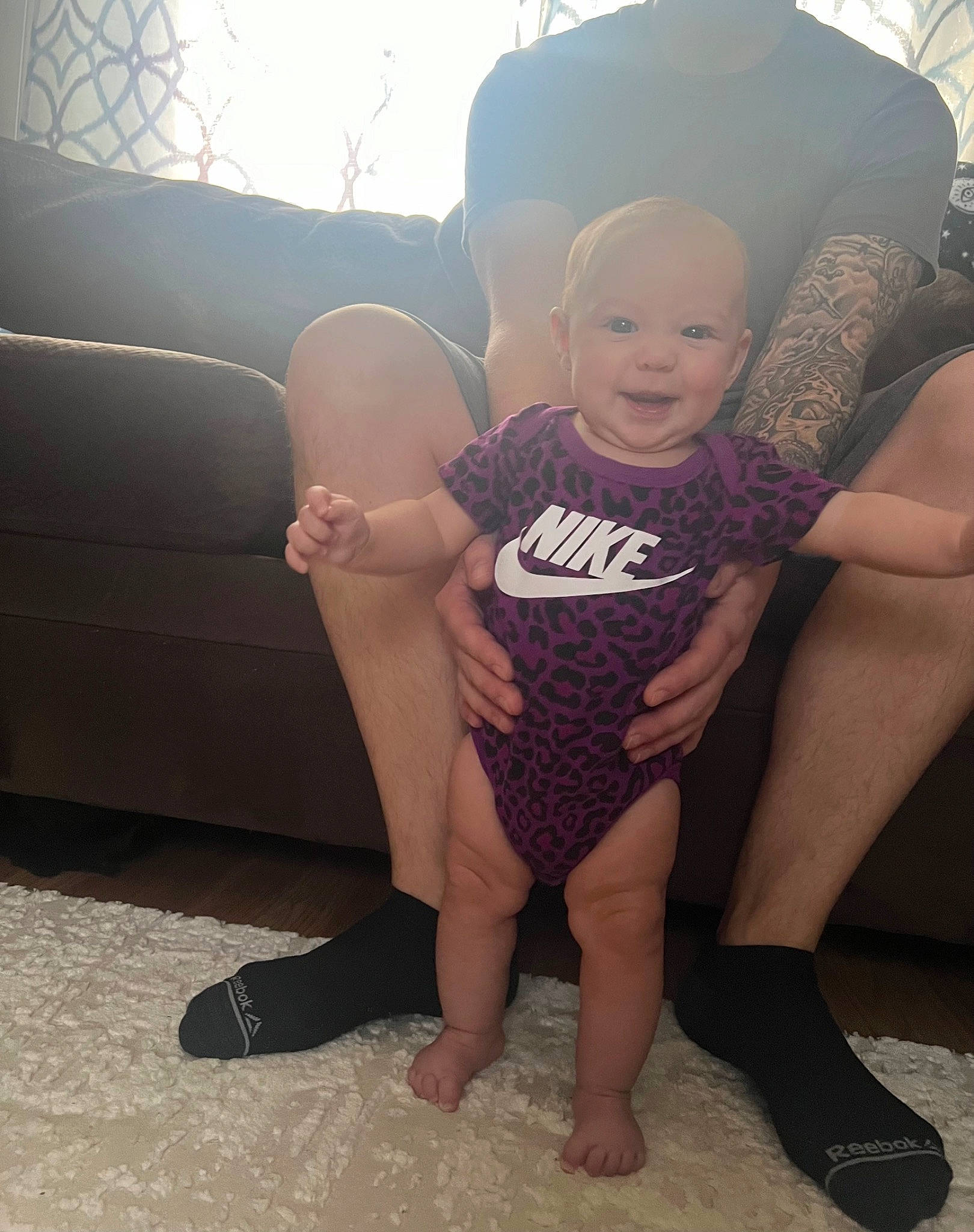 Millie is registered to the contest to win money with this photo: baby, comfort, couch, eye, finger, flash_photography, gesture, hand, happy, human_body, joint, knee, lap, leg, person, shoe, shoulder, skin, smile, thigh