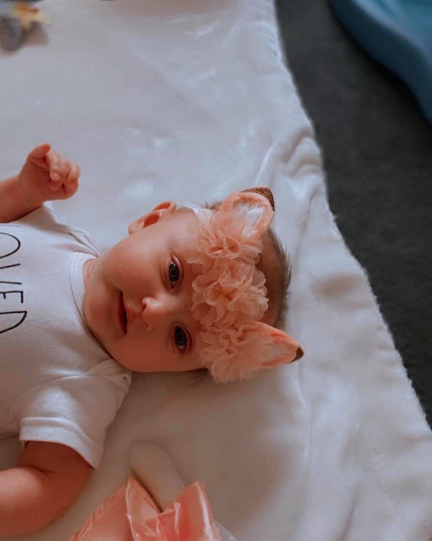 Kinslee is registered to the contest to win money with this photo: baby, baby_toddler_clothing, cheek, chest, child, comfort, eyelash, happy, headwear, linens, peach, person, sleeve, toddler