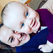 Hendrix is registered to the contest to win money with this photo: adult, baby, blue_eyes, child, close_up, couch, cozy, face, family, hand, happy, head, hug, indoor, love, person, portrait, skin, smiling, sweater