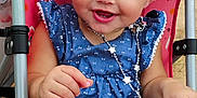 Eliza joined the competition — help win amazing prizes! baby, smiling, child, stroller, necklace, blue_dress, pink, rainbow_pattern, happy, cute, infant, sitting, outdoor, face, hand, legs, accessory, joy, people, portrait