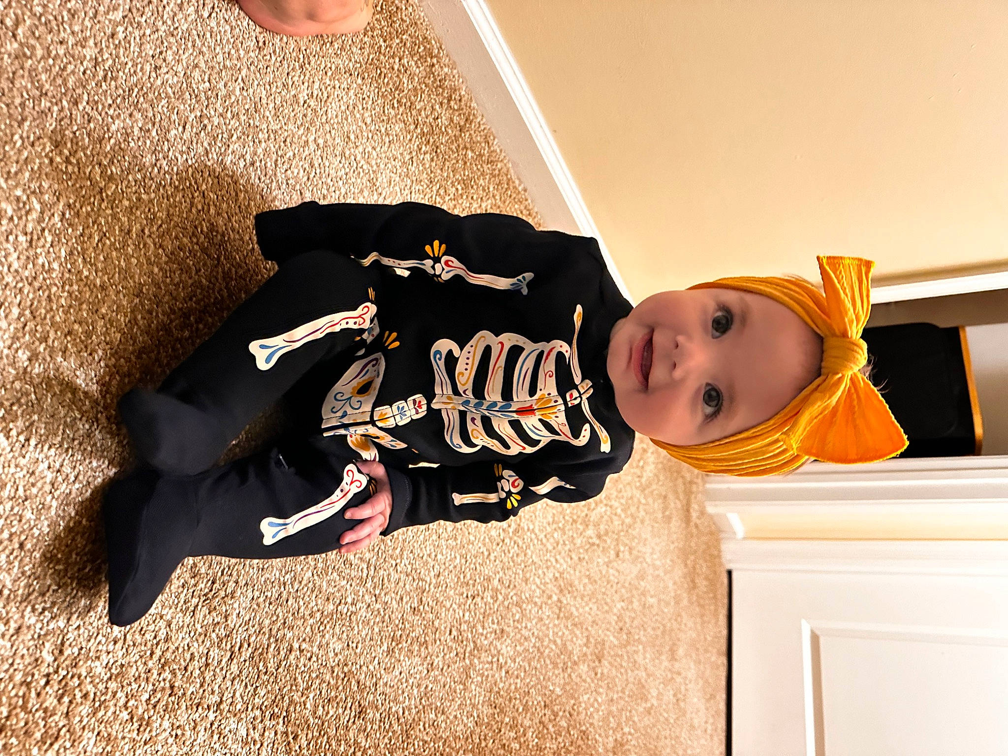 Myli is registered to the contest to win money with this photo: baby, baby_toddler_clothing, cabinetry, child, comfort, couch, drawer, flooring, fun, happy, hat, human_leg, joy, person, room, shadow, sitting, sleeve, smile, t_shirt