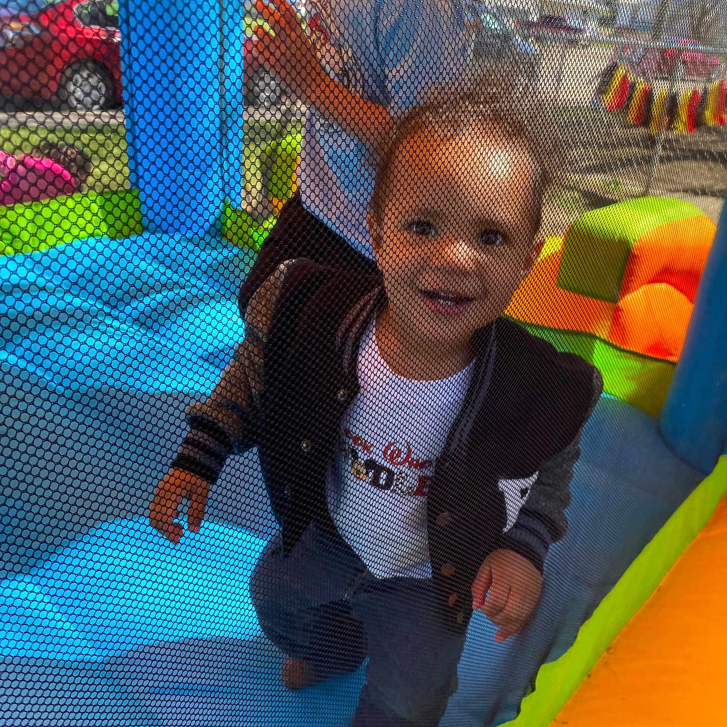 Micah is registered to the contest to win money with this photo: baby, car, clothing, face, head, indoors, inflatable, machine, outdoorplayarea, outdoors, pants, person, photography, playarea, portrait, slide, toy, transportation, vehicle, wheel