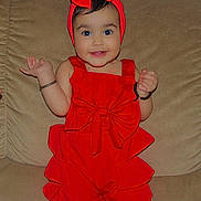 Gurbani Kaur is registered to the contest to win money with this photo: toddler, child, red_clothing, headband, bow, couch, smile, bracelet, indoors, happy, person, footwear, cute, standing, baby, accessory, playful, fashion, portrait, home