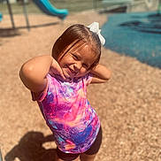 Leonarda is registered to the contest to win money with this photo: child, clothing, face, female, girl, grass, head, nature, outdoorplayarea, outdoors, park, person, photography, plant, playarea, portrait, purple, shorts, summer, swimwear