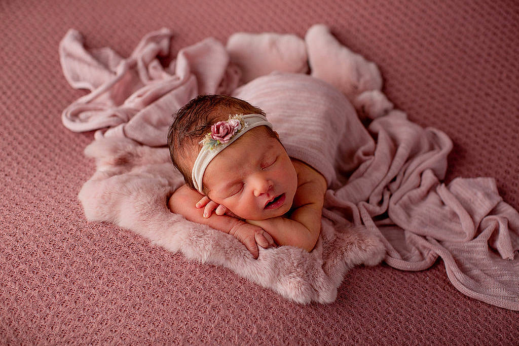 Vivian is registered to the contest to win money with this photo: baby, baby_products, baby_sleeping, baby_toddler_clothing, bedtime, cap, cheek, comfort, eye, face, fashion_accessory, grey, head, headwear, knit_cap, linens, nap, person, pink, textile