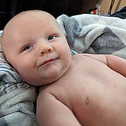 Atlas joined the competition — help win amazing prizes! baby, infant, skin, face, eyes, expression, blanket, comfort, relaxation, soft_texture, indoors, child, cute, closeup, portrait, naked_torso, head, cheeks, young, resting