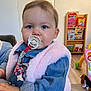 Livya participe au concours pour gagner de l'argent avec cette photo : baby, pacifier, pink_vest, denim_shirt, indoor, child, toy, bookshelf, floor, carpet, hand, face, blue_eyes, furniture, person, infant, cute, home, playroom, toddler