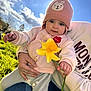 baby, child, clouds, cute, daffodil, flower, grass, hand, hat, holding, nature, outdoor, person, pink, portrait, sky, smile, spring, sunlight, warm_clothing