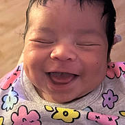 Priya joined the competition — help win amazing prizes! baby, child, close_up, clothing, cute, face, floral, happy, head, infant, joyful, newborn, pattern, person, pink, portrait, purple, skin, smiling, yellow