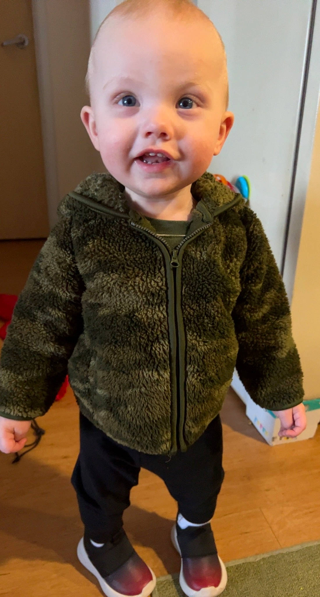 Brantley joined the competition — help win amazing prizes! baby, baby_toddler_clothing, cheek, child, floor, flooring, iris, joint, outerwear, pattern, person, skin, sleeve, smile, standing, thumb, toddler, top, wood, wool