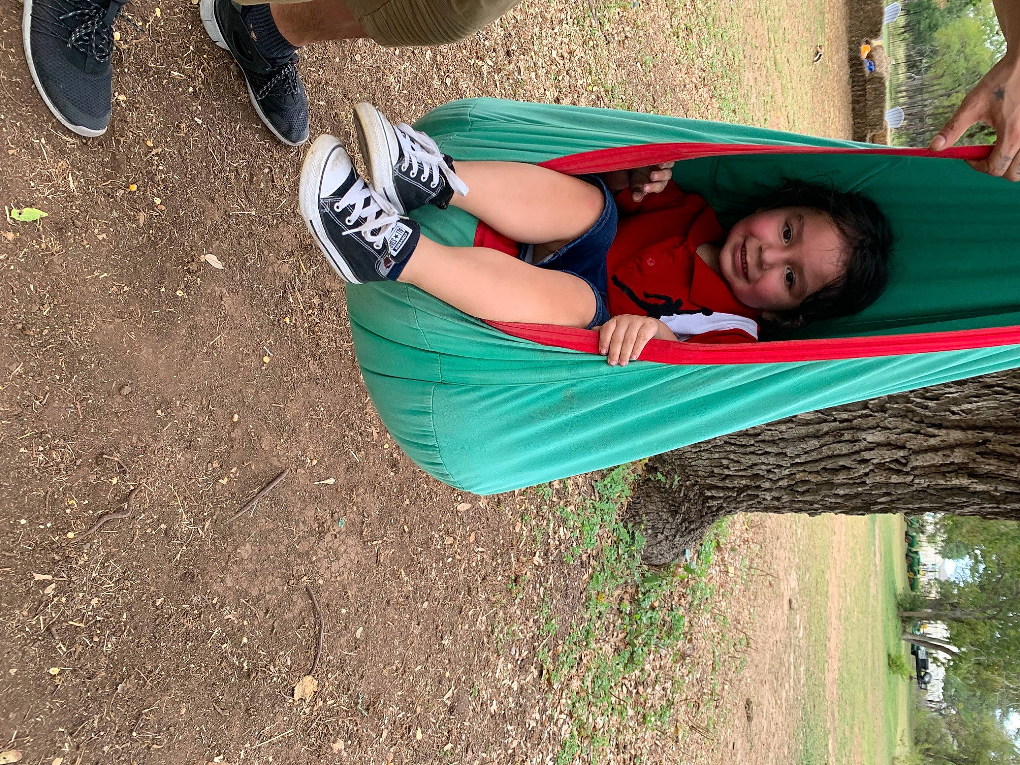 Ezekiel is registered to the contest to win money with this photo: athletic_shoe, elbow, grass, green, happy, human_leg, joy, knee, leisure, outdoor_shoe, people_in_nature, person, plant, recreation, smile, soil, t_shirt, thigh, tree, trunk