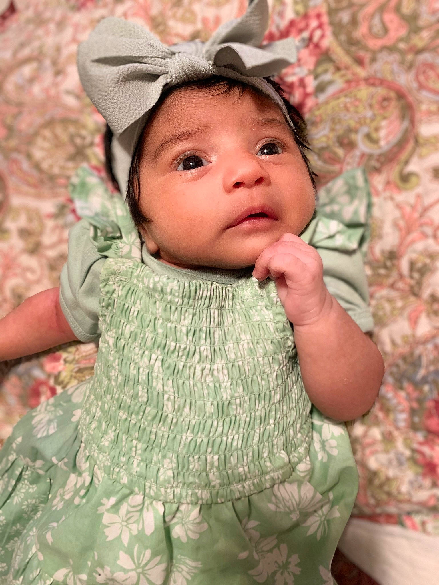 Millannii is registered to the contest to win money with this photo: baby, baby_toddler_clothing, cap, cheek, child, dress, embellishment, face, fashion_accessory, grass, happy, headwear, iris, lip, pattern, person, pink, skin, sleeve, textile