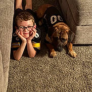 Bear joined the competition — help win amazing prizes! boy, child, glasses, dog, pet, carpet, couch, indoor, smiling, lying_down, black_jersey, matching_outfits, home, cozy, furniture, relaxed, cute, portrait, young, friendship