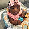 Leilani is registered to the contest to win money with this photo: activity_seat, adorable, baby, baby_toys, child, close_up, colorful, couch, curly_hair, happy, headband, home, indoor, infant, pink_bow, playtime, portrait, sitting, smiling, teether