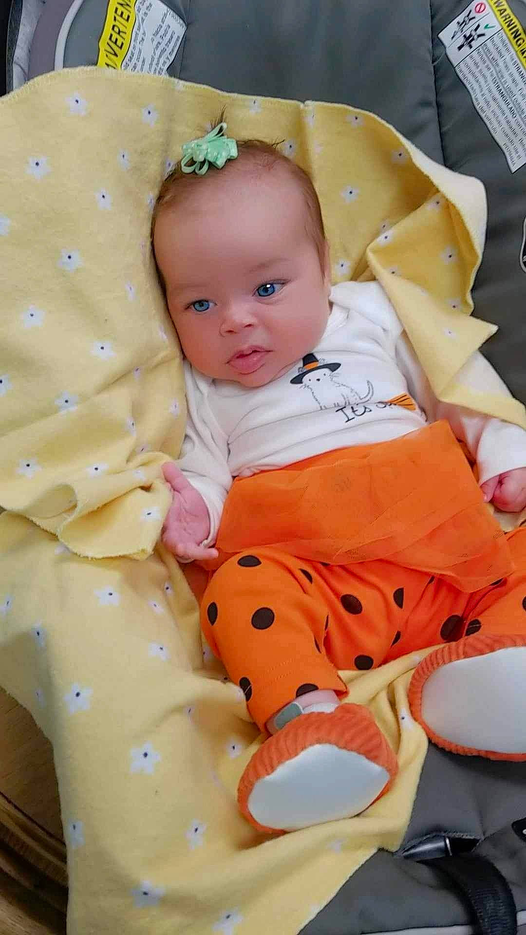 Lilyana is registered to the contest to win money with this photo: baby, baby_products, baby_toddler_clothing, carmine, cheek, child, comfort, eye, happy, head, linens, orange, pattern, peach, person, pink, sitting, sleeve, textile, toddler