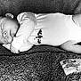 baby, sleeping, blanket, onesie, infant, peaceful, texture, fabric, foot, hand, face, couch, cozy, rest, black_and_white, portrait, cute, child, soft, relaxation