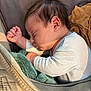 baby, blanket, closeup, clothing, cozy, cushion, face, head, human, indoors, infant, newborn, peaceful, person, resting, sleeping, soft, toddler, warm_light, wrapped