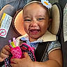 Alivia joined the competition — help win amazing prizes! baby, child, smiling, car_seat, headband, toy, happy, cute, infant, clothing, seatbelt, portrait, closeup, face, hand, fabric, colorful, indoor, person, baby_toy