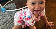 Alivia joined the competition — help win amazing prizes! baby, child, crawling, floor, wooden_floor, rug, baby_walker, headband, bow, smiling, happy, indoor, clothing, pink, blue, floral_pattern, person, infant, cute, home