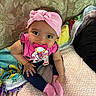 Alivia joined the competition — help win amazing prizes! baby, child, pacifier, pink_headband, pink_socks, blanket, couch, colorful_blanket, infant, indoors, cute, sitting, clothing, person, portrait, soft_texture, hand, foot, headwear, expression