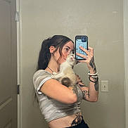 Akimitsu joined the competition — help win amazing prizes! person, cat, mirror, selfie, kitten, tattoos, phone, smartphone, bracelet, bathroom, mirror_selfie, door, light_switch, wall, crop_top, pigtails, reflection, holding, portrait, home_interior