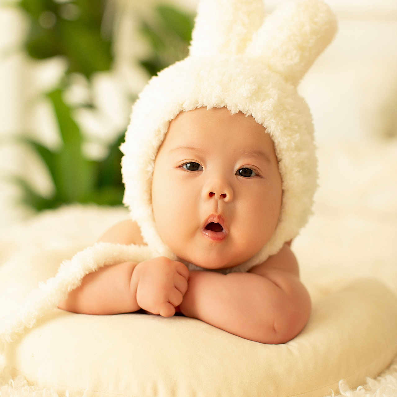 Kendrick is registered to the contest to win money with this photo: baby, blanket, bodypart, bonnet, cap, clothing, face, finger, hand, happy, hat, head, hood, newborn, person, photography, portrait, sitting, smile, towel