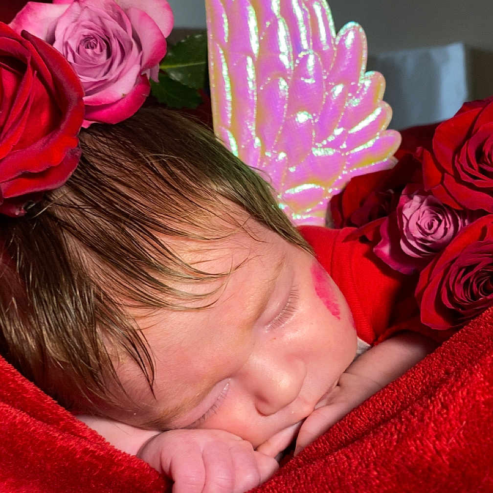 Ivy is registered to the contest to win money with this photo: baby, blanket, bodypart, couch, face, finger, flower, flowerarrangement, flowerbouquet, furniture, hand, head, newborn, person, petal, photography, plant, portrait, rose, sleeping