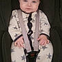 baby, child, car_seat, onesie, stars, infant, blue_eyes, straps, seatbelt, sitting, clothing, cute, portrait, indoors, young_child, baby_girl_or_boy, smiling, hands, feet, cozy