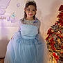 birthday, blue_dress, butterfly, celebration, child, christmas_tree, decorations, dress, festive, floor, girl, holiday, indoor, lace, lighting, party, portrait, smile, tiara, tulle
